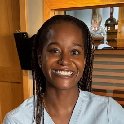 Victoria smiling in a white shirt.